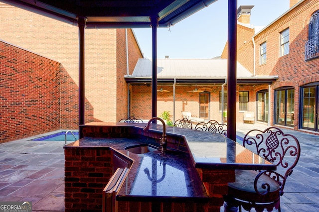 view of patio with an outdoor wet bar and ceiling fan