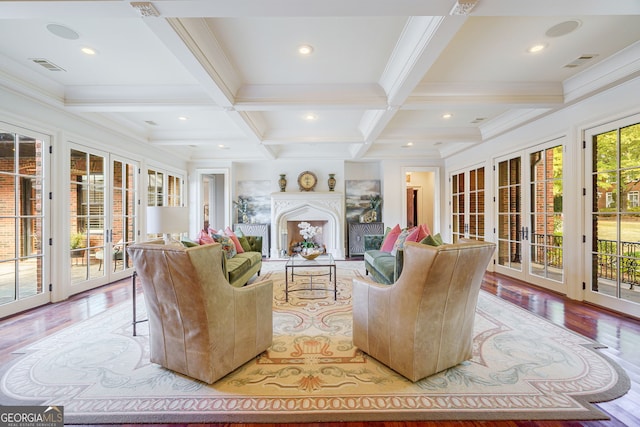 living room with french doors, coffered ceiling, ornamental molding, beamed ceiling, and light wood-type flooring