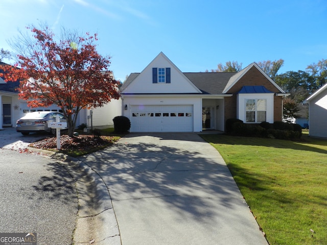 view of property featuring a front yard and a garage