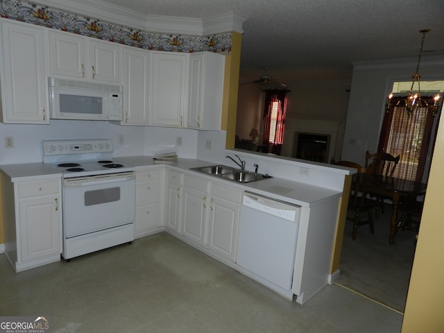 kitchen featuring white cabinets, kitchen peninsula, sink, pendant lighting, and white appliances