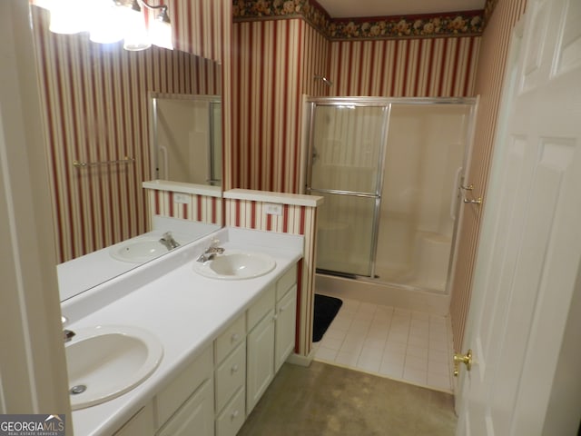 bathroom featuring vanity, a shower with door, and tile patterned flooring