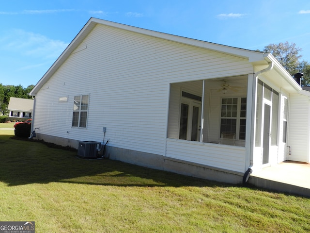 view of home's exterior with central air condition unit, a sunroom, a yard, and ceiling fan