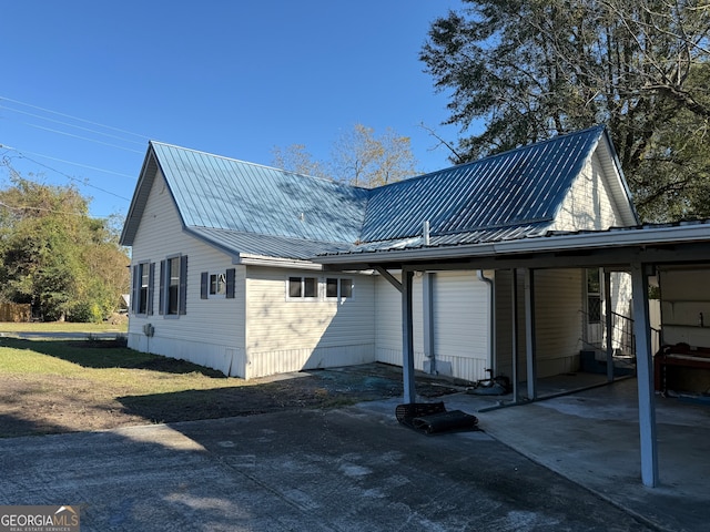 rear view of property with a carport