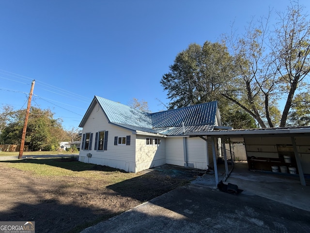 view of side of property with a carport