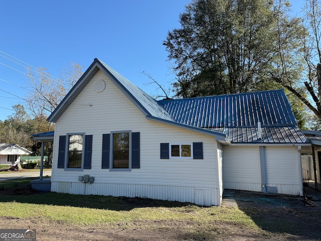 rear view of property featuring a yard