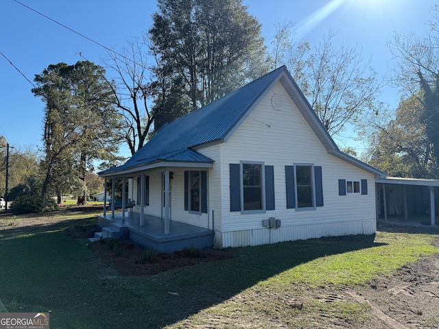 view of side of home with a porch and a lawn