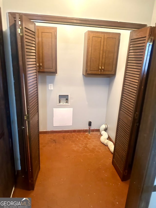 clothes washing area featuring cabinets and hookup for a washing machine