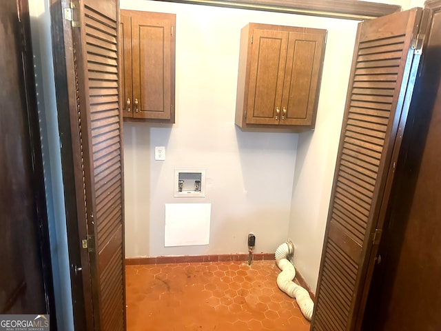 laundry area with hookup for a washing machine and cabinets