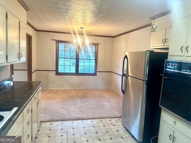 kitchen featuring black oven, hanging light fixtures, a notable chandelier, white cabinets, and stainless steel fridge