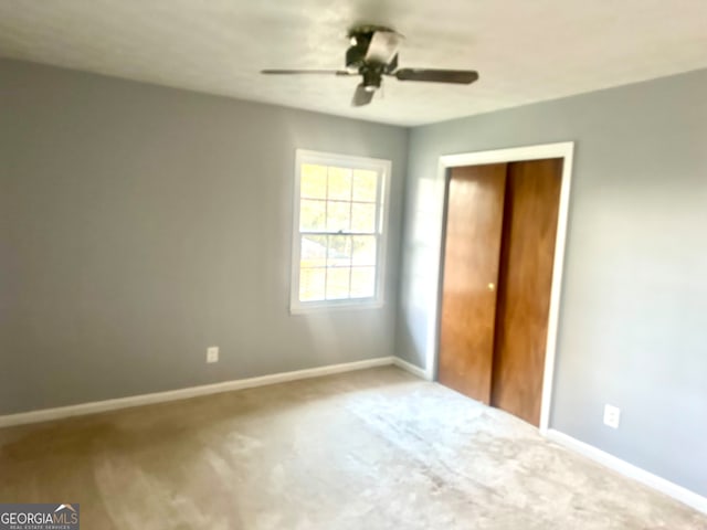 unfurnished bedroom featuring a closet, ceiling fan, and carpet floors