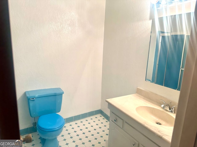 bathroom featuring vanity and toilet