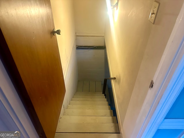 staircase with wood-type flooring