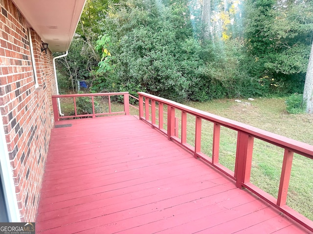 wooden terrace with a lawn