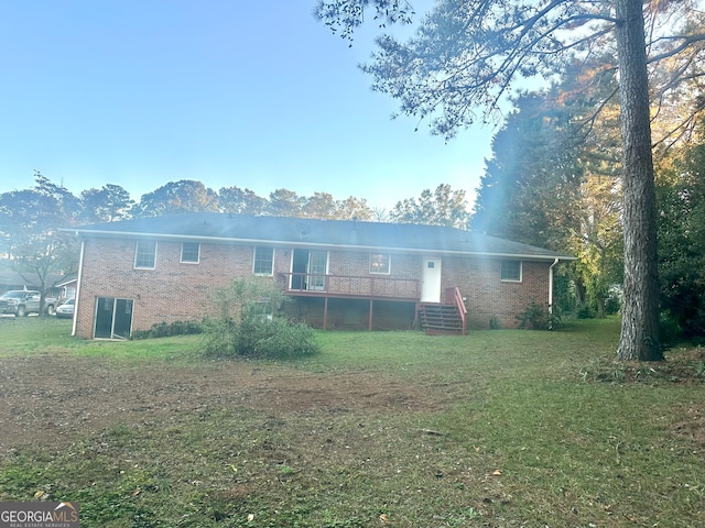 back of house with a wooden deck and a yard