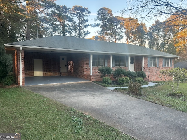 single story home featuring a front yard and a carport