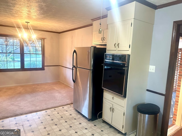 kitchen featuring stainless steel refrigerator, oven, a chandelier, white cabinets, and pendant lighting