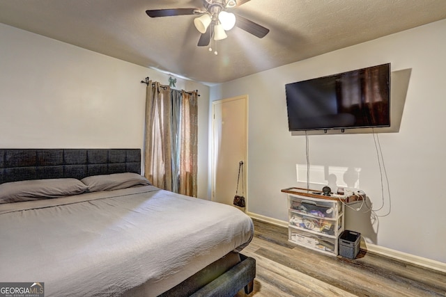 bedroom featuring hardwood / wood-style floors and ceiling fan