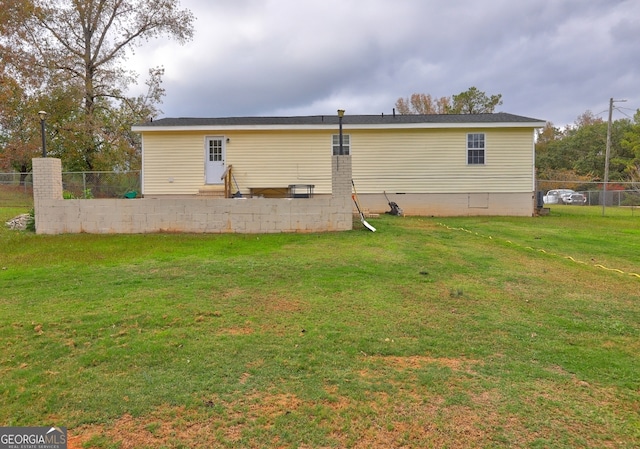 back of house with a yard