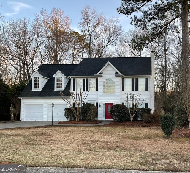 view of front of house with a garage and a front yard