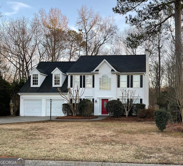 view of front facade featuring a garage and a front yard