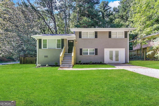 split level home with french doors and a front lawn