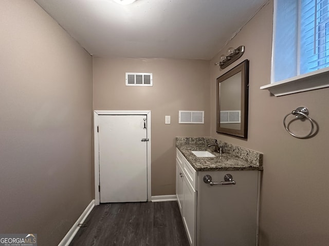 4310 Bakers Ferry Rd SW, Atlanta, GA 30331 - bathroom with wood finished floors, baseboards, and vanity