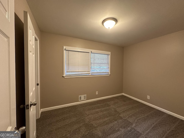4310 Bakers Ferry Rd SW, Atlanta, GA 30331 - unfurnished bedroom featuring dark carpet and baseboards