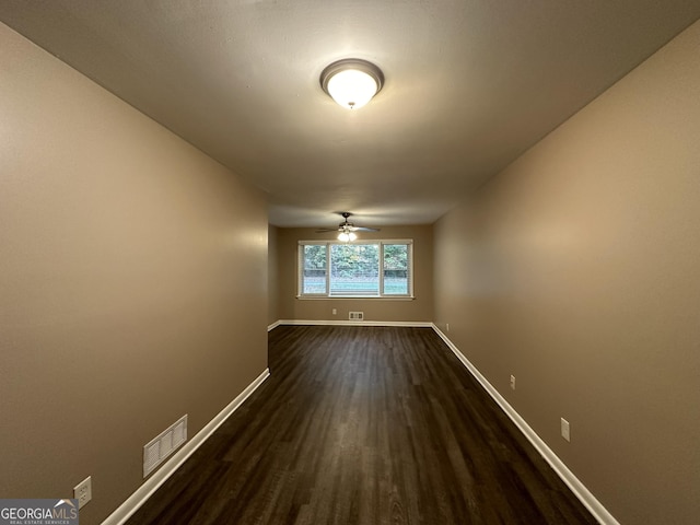 4310 Bakers Ferry Rd SW, Atlanta, GA 30331 - spare room with dark wood-style floors, baseboards, and ceiling fan