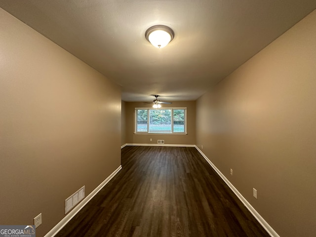 unfurnished room with dark hardwood / wood-style floors and ceiling fan