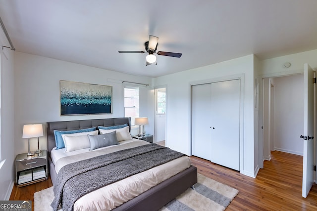 bedroom featuring hardwood / wood-style flooring, ceiling fan, and a closet