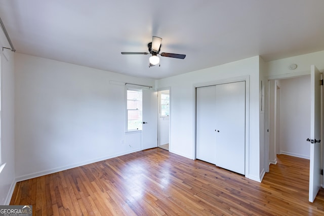 unfurnished bedroom featuring wood-type flooring, a closet, and ceiling fan