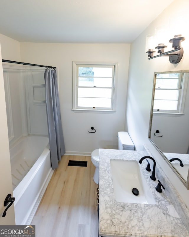 full bathroom with wood-type flooring, vanity, toilet, and shower / bath combo