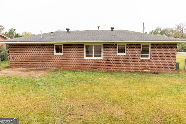 rear view of house with a lawn