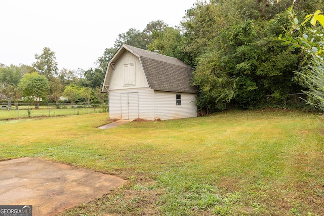 view of outbuilding featuring a lawn