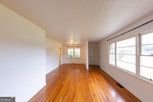 spare room featuring light wood-type flooring