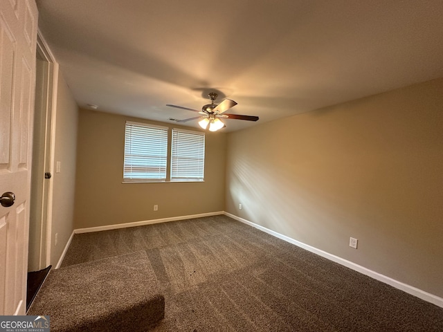 empty room with ceiling fan and carpet floors