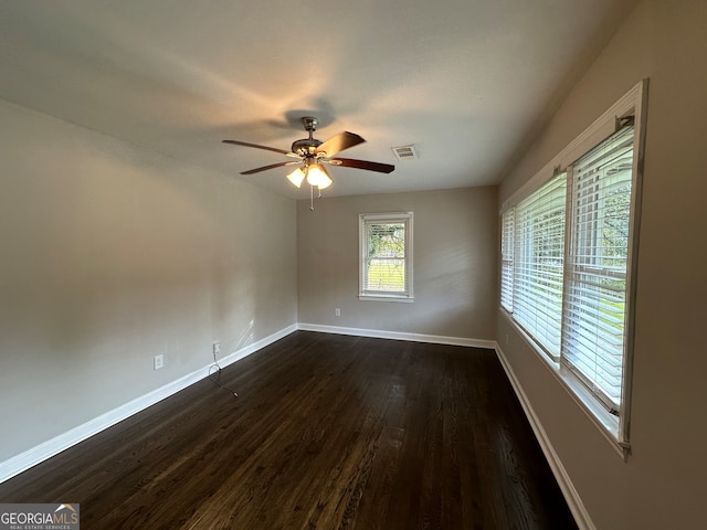 spare room with dark wood-type flooring and ceiling fan