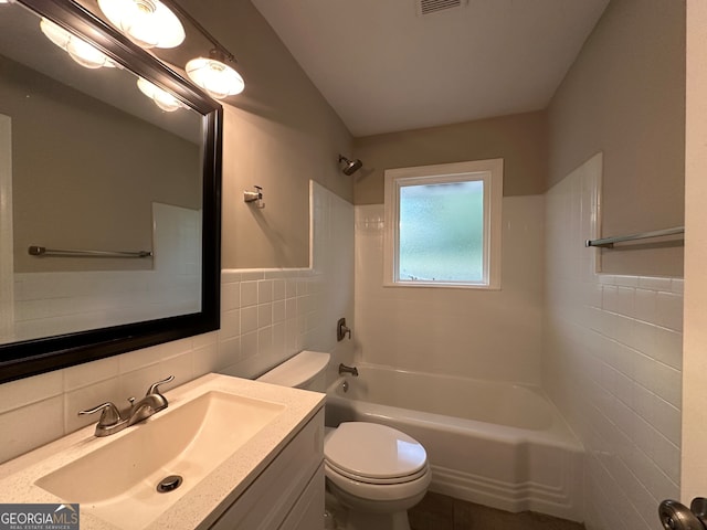 full bathroom featuring  shower combination, vanity, toilet, and tile walls