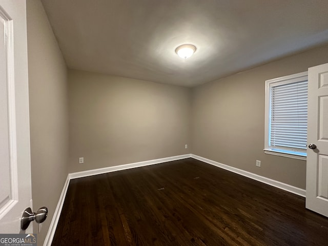 spare room featuring dark hardwood / wood-style floors