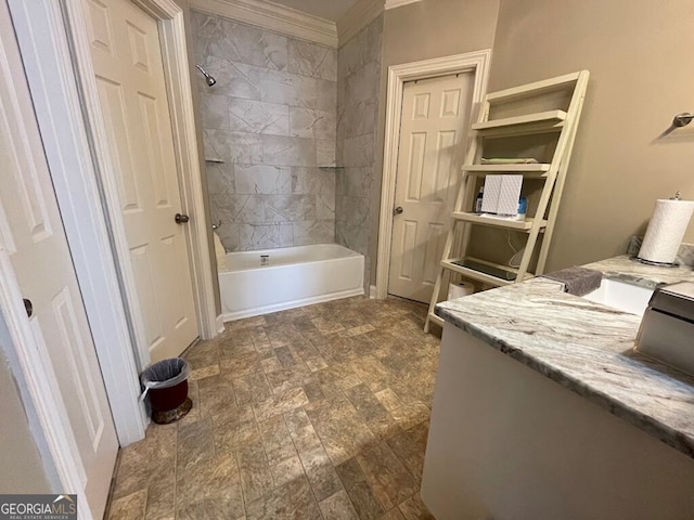 bathroom featuring vanity, crown molding, and tiled shower / bath combo