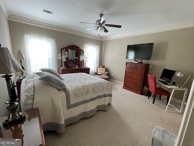 carpeted bedroom with ceiling fan and crown molding