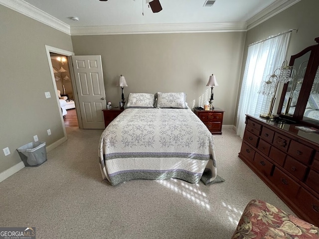 carpeted bedroom featuring ceiling fan and crown molding