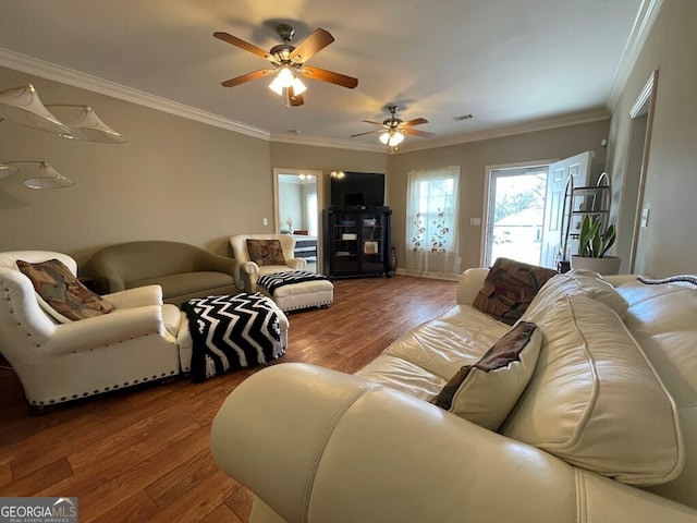 living room featuring hardwood / wood-style flooring, crown molding, and ceiling fan