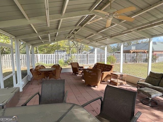 sunroom featuring ceiling fan and vaulted ceiling