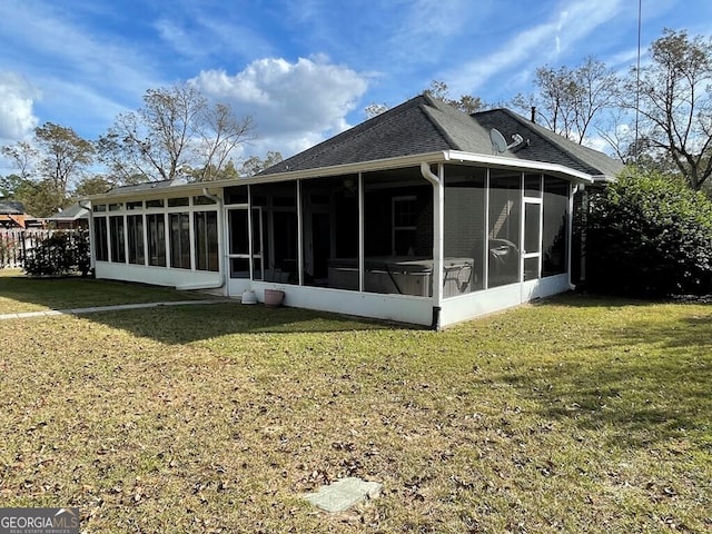 back of house with a lawn and a sunroom