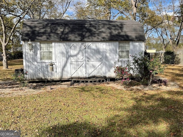 view of outbuilding featuring a yard