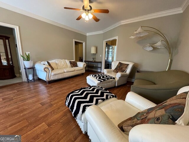 living room featuring ornamental molding, dark hardwood / wood-style flooring, and ceiling fan