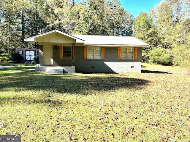 ranch-style home with a front yard and a storage unit