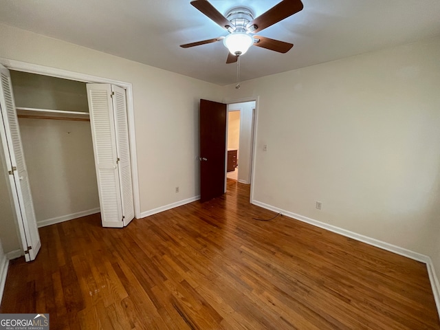 unfurnished bedroom featuring ceiling fan and dark hardwood / wood-style floors