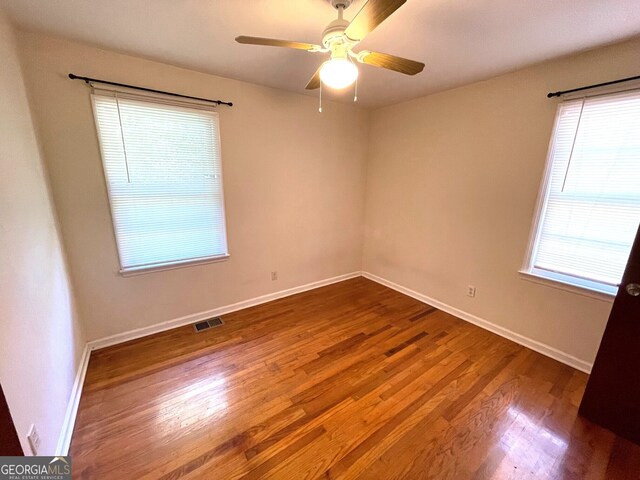 empty room featuring hardwood / wood-style floors and ceiling fan